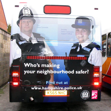 bus back advertising the hampshire police, bloke has an exhaust pipe over his cock!